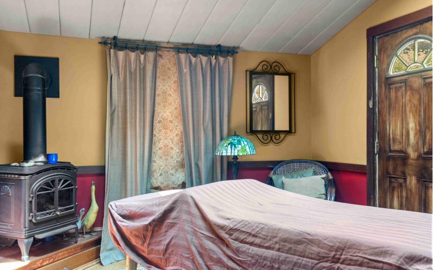 Studio corner with wood stove and Tiffany lamp